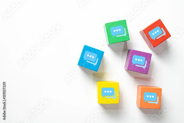 Fototapeta Colorful wooden blocks with chat speech bubble icons on white background with copyspace.Concept of communication,social media, messaging,online conversation,discussion forum, and customer feedback.