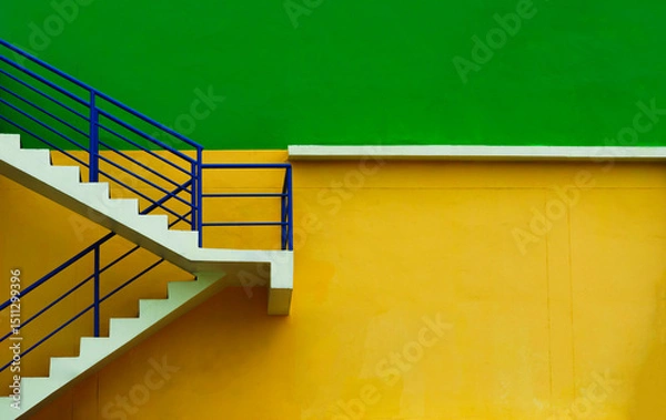 Fototapeta Modern staircase with blue railing against vibrant green and yellow wall, minimalist urban architecture, Emergency exit highlight minimalist architecture Clean structure of the building exterior.