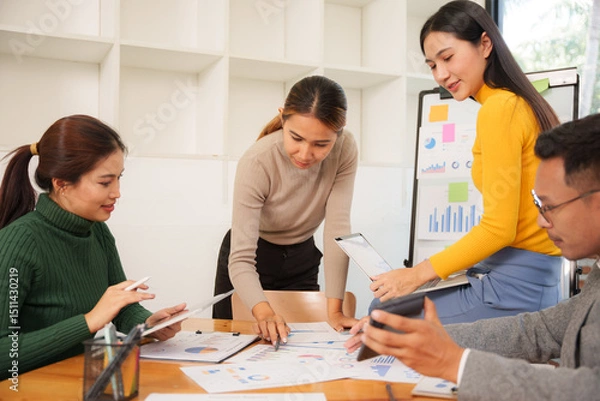 Fototapeta Group of Asian business people working together in an office
