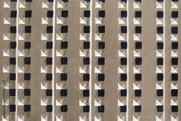 Obraz Perfect geometry of shadows and umbrellas on a deserted beach seen from above