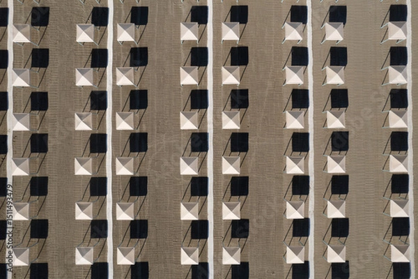 Obraz Perfect geometry of shadows and umbrellas on a deserted beach seen from above
