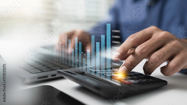 Obraz Close up businessman hand using calculator to financial management and Business finance accounting banking planning concept. Tax calculation to financial report Management of debt and budget