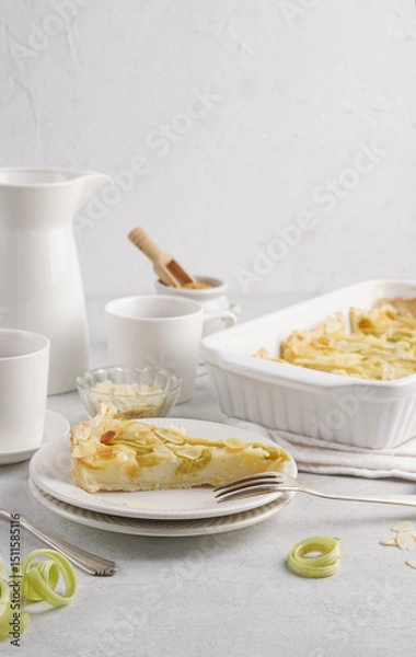 Obraz A slice of rhubarb pie or tart on a white plate Rhubarb Pie or Tart with sour cream filling . Healthy homemade summer dessert, Top view, copy space. Summer healthy dessert. Selective focus, copy space