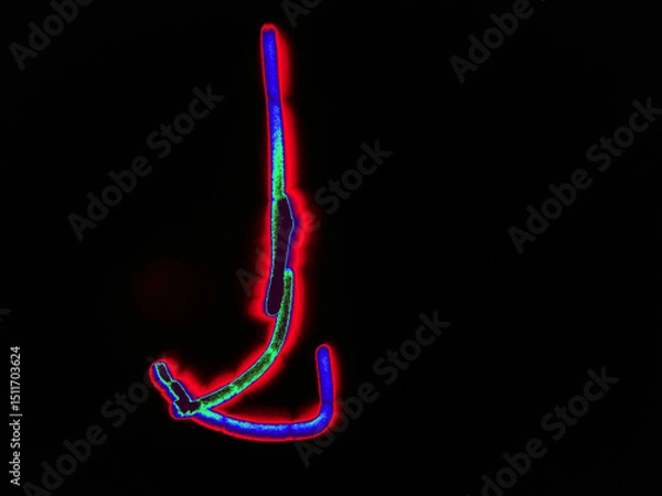 Fototapeta Glowing English letter J. On a black background with colored neon lines, a letter of the English alphabet is written by hand. The letter glows pink-red, creating a green-blue halo around it.