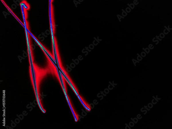 Fototapeta Glowing English letter N. On a black background with colored neon lines, a letter of the English alphabet is written by hand. The letter glows pink-red, creating a green-blue halo around it.