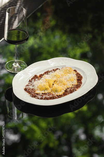 Fototapeta Portion of italian ravioli dumplings with minced beef and wine