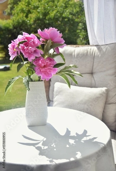 Obraz Peonies in a vase on a table on the terrace.