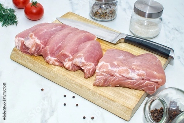 Obraz Pieces of pork on a wooden board