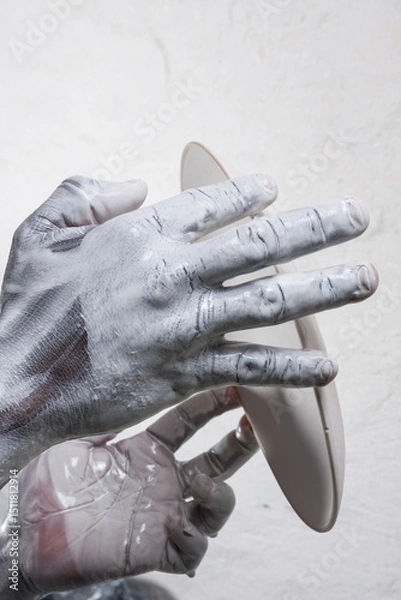 Obraz strong active hands working with pottery during the glazing process textured 