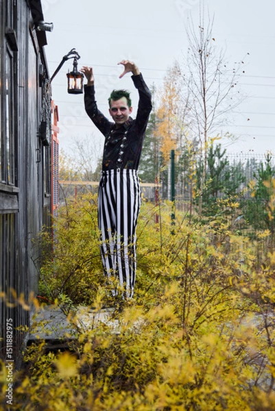 Fototapeta A jester embracing autumn vibes in colorful striped pants, full of joy and cheer