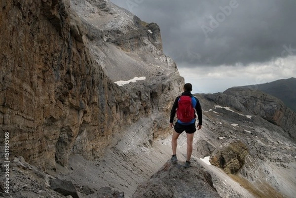 Fototapeta A hiker looking away from Brecha de Rolando towards Casco and Paso de los Sarrios in the Ordesa Park in the Spanish Pyrenees