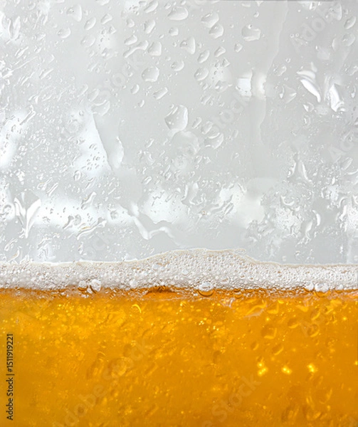 Fototapeta Macro view of glass with fresh beer surface with bubbles
