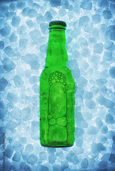 Fototapeta Green beer bottle buried on pile of ice cubes backlit