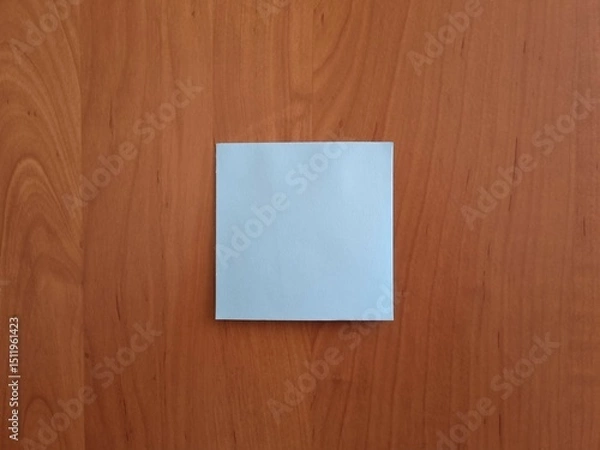 Obraz Blank square blue note paper on wooden surface. Note for notes and reminders