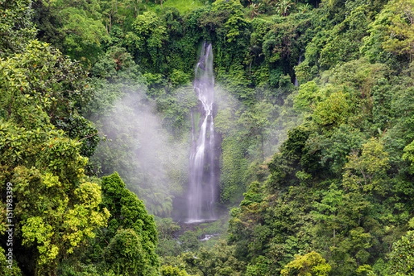 Obraz One of many waterfalls at Sekumpul waterfall, northern Bali, Indonesia. Mist rising from the water; surrounded by lush green cliffs.
