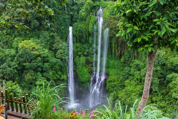 Obraz Three separate wateralls falling down steep cliff to pool below. Sekumpul waterfall, northern Bali, Indonesia. Lush green cliff in the background.
