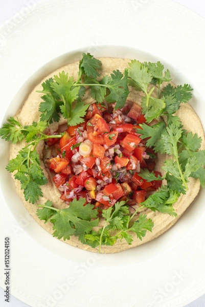 Fototapeta Portion of hummus appetizer with chopped pepper and onion