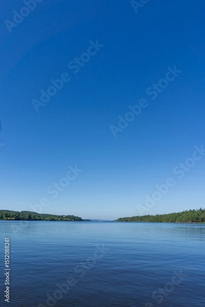 Fototapeta Tranquil View of Rødenessjøen Surrounded by Pine Forest in Norway