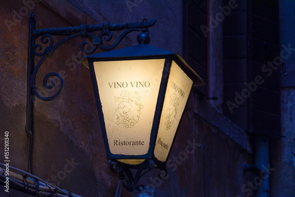 Fototapeta Glowing lantern with the inscription Wine on the street of Venice
