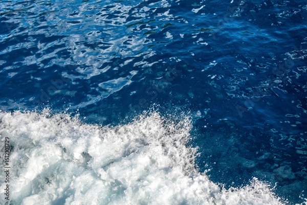 Fototapeta Blue sea texture background with water swirls and white foam