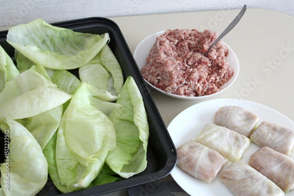 Obraz Cabbage leaves, homemade minced meat with rice, products for making cabbage rolls.