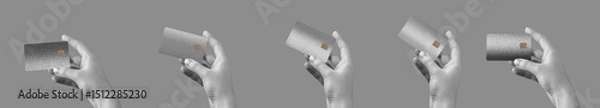 Obraz A hand holding a premium credit card, showcasing secure, cashless payment. Elegant gray and black