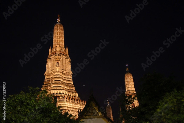 Obraz Wat Arun, also known as the Temple of Dawn, is beautifully illuminated at night in Bangkok, Thailand. 