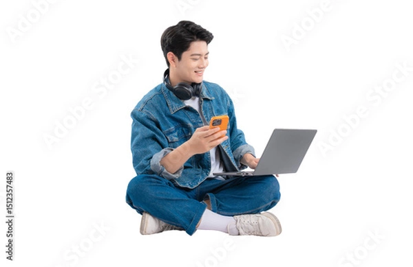 Fototapeta Full body image of Asian guy using laptop and phone on png background	