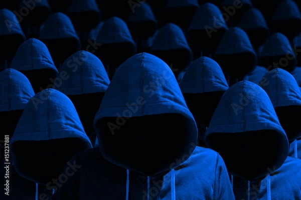 Fototapeta Group of hooded hackers in blue cybersecurity concept