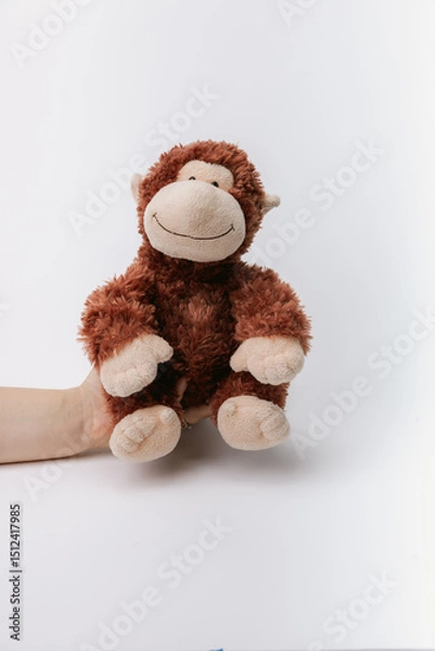 Obraz Monkey stuffed animal sitting on a white background