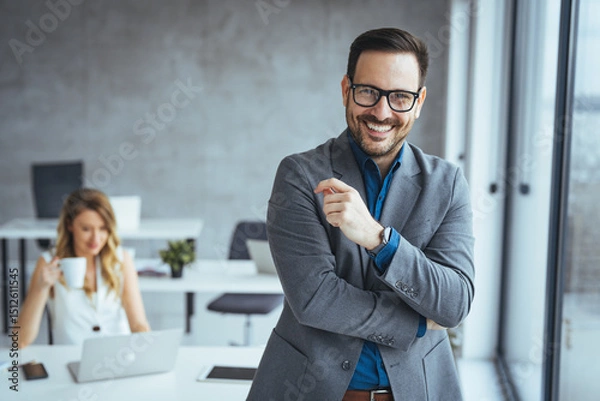 Fototapeta Confident Businessman Smiling in a Modern Office Environment
