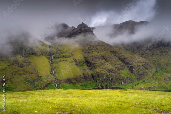 Obraz A stunning Carrauntoohil mountain scene, enveloped in thick mist, showcases vibrant greenery and towering rugged peaks in a truly serene setting that captures the imagination, Kerry, Ireland