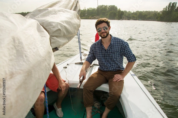 Obraz young men steer the boat