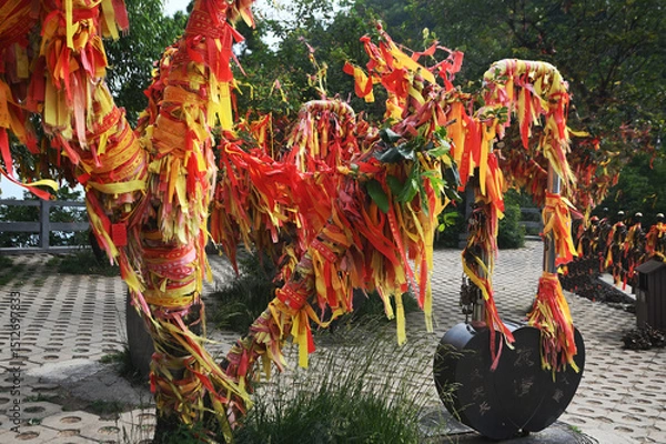 Obraz Red ribbons or cloth talismans tied to pillars in Taoist temples at Yuntaishan Geopark is the most beautiful geopark in Henan Province, China.It is listed as the first World Geopark in the world.