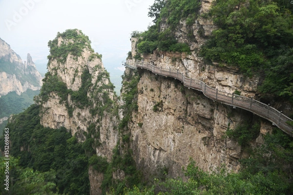 Obraz Walkway on the Cliff in Yuntaishan Park is the most beautiful geological park in Henan Province, China. It is listed as the first geological heritage site in the world and is a 5A-level tourist.