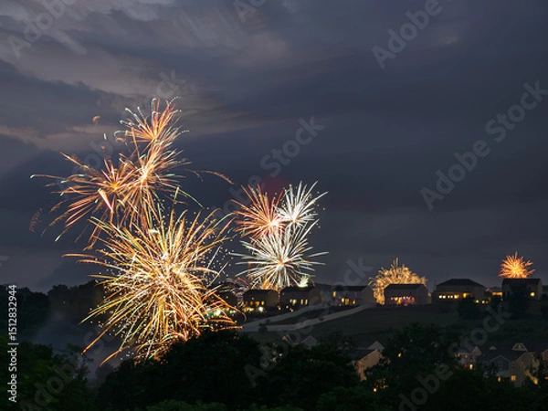 Obraz Fireworks over a residential area in USA on a summer evening.