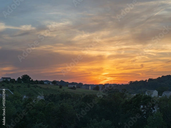 Obraz Dramatic sunset over suburbia, with warm colored houses