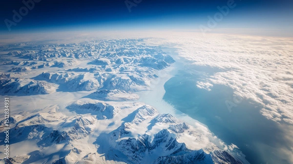 Fototapeta Aerial view of Antarctica's icy coastline with dramatic glaciers meeting the deep blue ocean, vast copy space for text overlay. Polar landscape, climate change, global warming and environmental conser