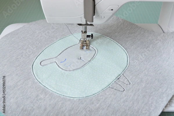 Fototapeta Cute sheep applique working process: sewing machine and fabric pieces