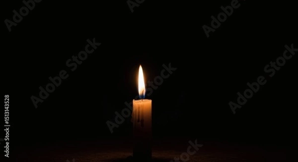 Obraz A single candle flame burning brightly in the darkness casting a soft glow around the wax candle body