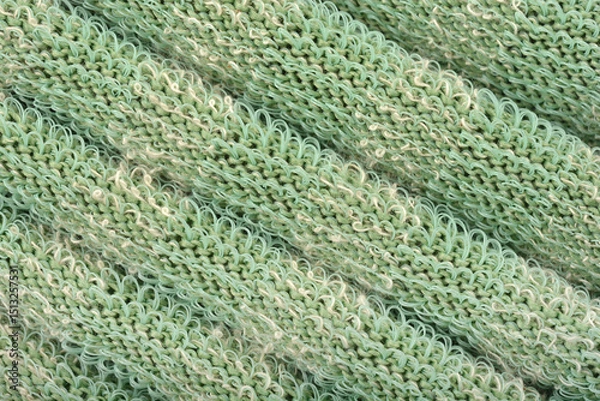 Obraz A macro detail of green knitted fabric with a unique texture and protruding plastic threads