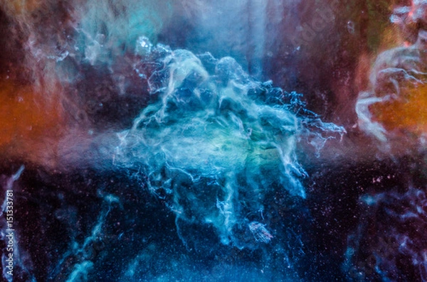 Fototapeta Ice art. Many colors lights behind the ice. Frozen water pattern inside.