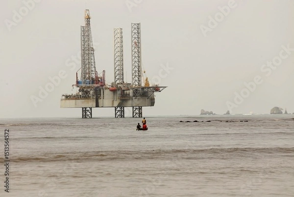 Obraz Cameroon ocean coast with an oil platform in the background and Cameroonians fishing with their boats in the foreground