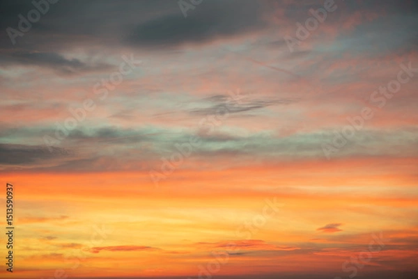 Fototapeta Sky,Beautiful sunset view, luxury soft gradient orange gold clouds and sunlight on the blue dramatic sky perfect for the background, morning, evening,Twilight, climate change,horizontal sunset photo