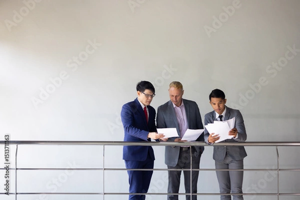 Fototapeta Business meeting : Business colleagues talking in the office. Group of business man talking in modern office building