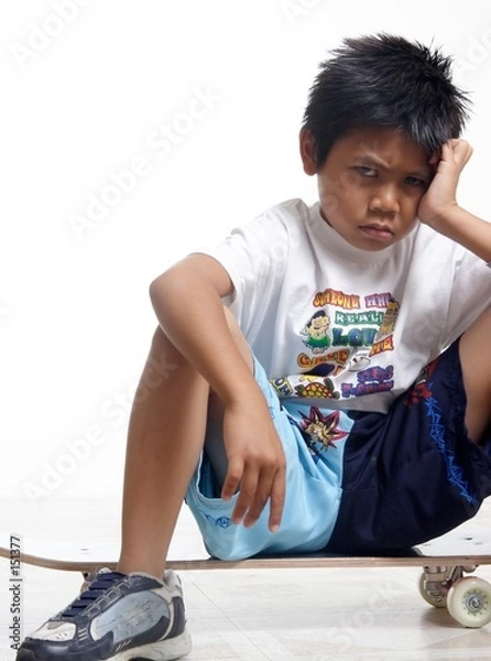 Obraz pouting boy sitting on his skateboard