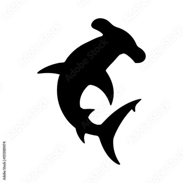 Fototapeta Silhouette of a hammerhead shark swimming gracefully in the ocean water with its unique head shape shown