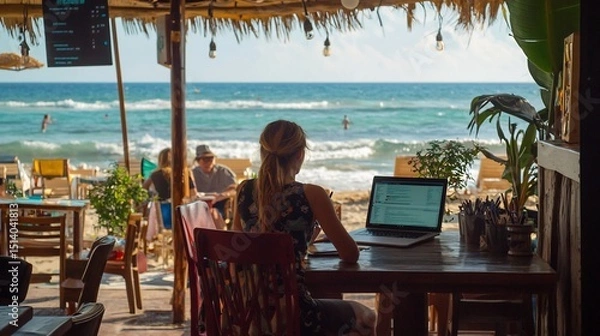 Fototapeta Digital nomad working from a beachside caf laptop relaxed business environment