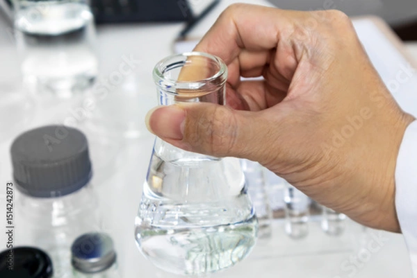 Obraz Researchers pick up scientific experiment bottles to study and develop new chemical formulas