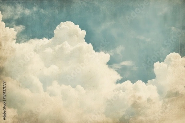 Fototapeta Vintage clouds fill the sky with a soft blue hue, providing ample copyspace for creative design or textual overlay in a serene atmospheric setting